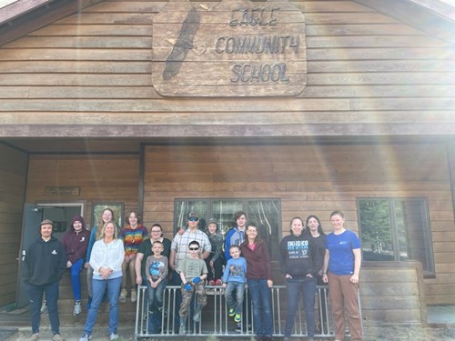 Students of Eagle Community School, the principal Kristy Robbins, and the Fresh Eyes on Ice and Alaska Satellite Facility team stand in front of Eagle Community School