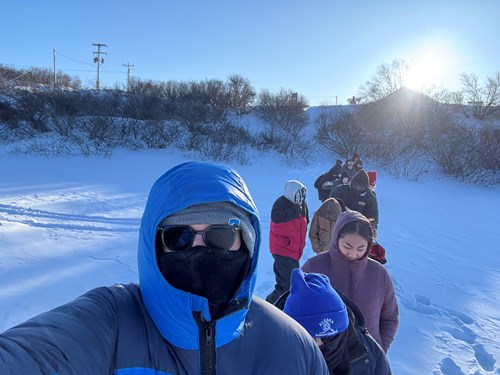 Selfie of a researcher and students on a frozen lake
