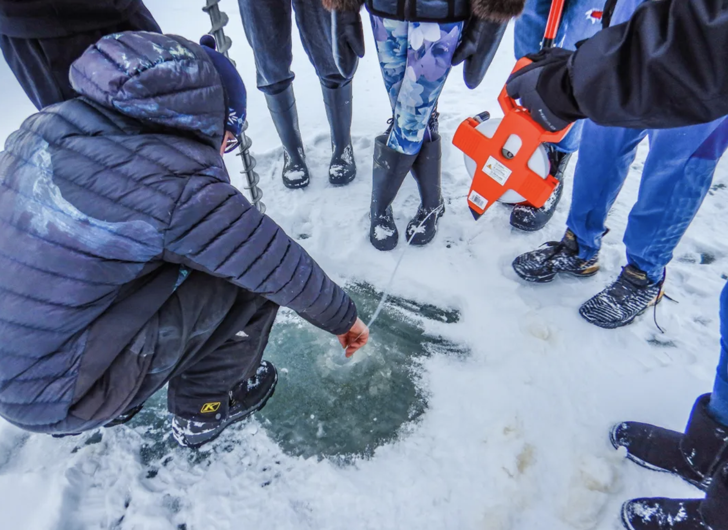 Students in Noatak in northwest Alaska take ice measurements. Photo: Brett Pietila